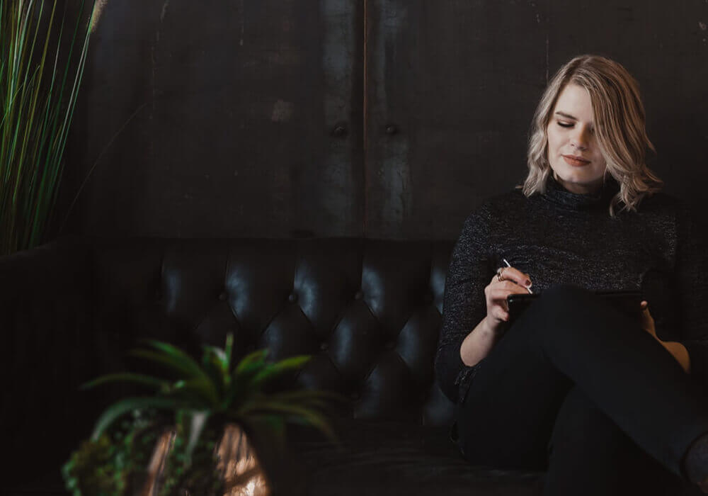 women sitting down looking at ipad