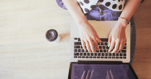 writing on laptop keyboard 